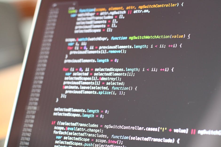 A close-up view of a computer screen displaying colorful programming code with syntax highlighting in multiple colors including pink, green, blue, and yellow. The text appears to be JavaScript, with v